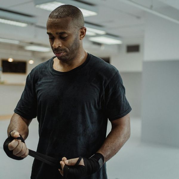 Man in a calm, focused state after completing a workout session.